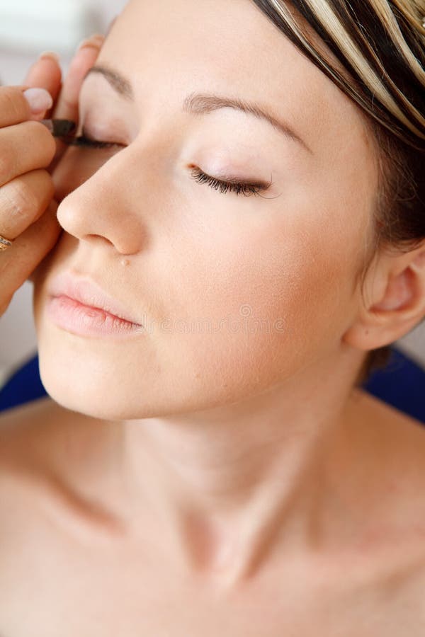 Young woman directs a make-up in the morning