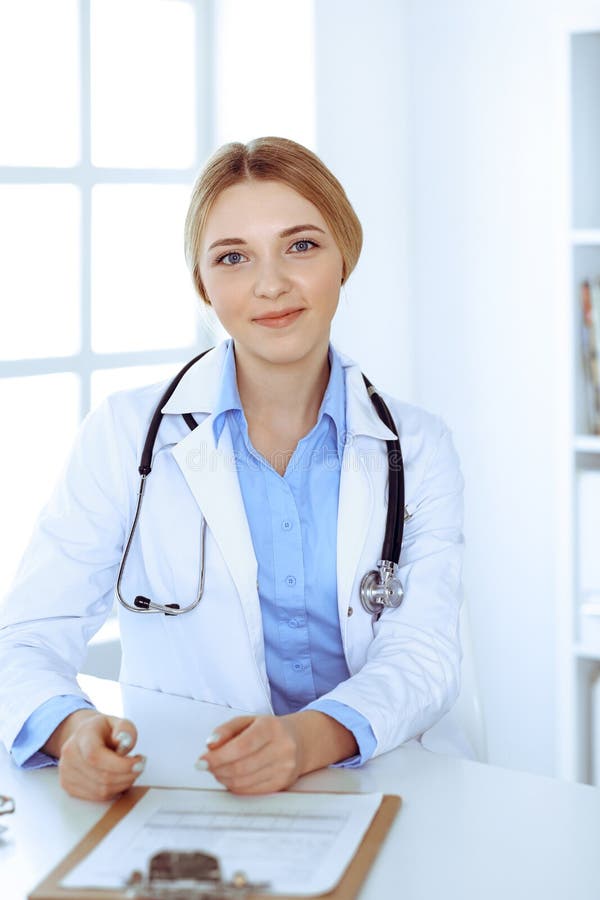 Young Woman Doctor at Work while Filling Up Medication History Records ...