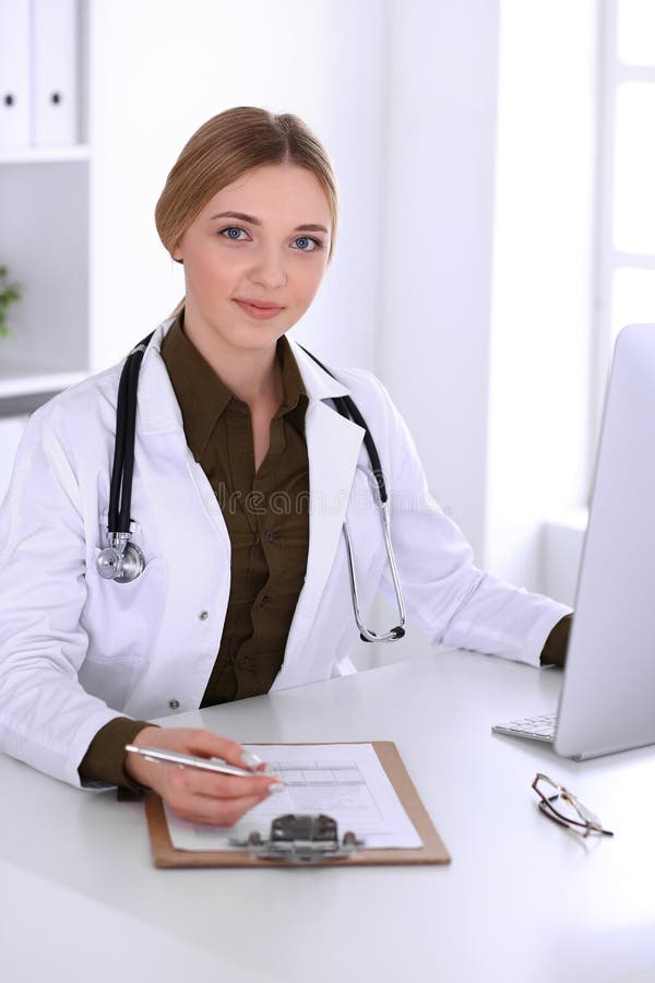 Young Woman Doctor At Work In Hospital Looking At Desktop Pc Monitor Physician Controls 