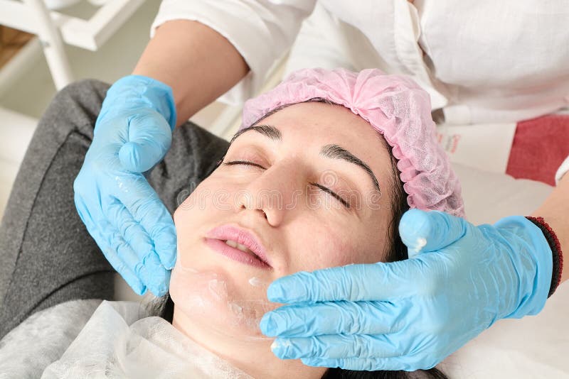 Young woman does professional facial massage in the beauty salon royalty free stock photo Young woman does professional facial massage in the beauty salon royalty free stock photo