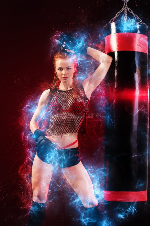 Woman sportsman boxer doing boxing training at the gym. Girl wearing gloves, sportswear about punching bag. Energy stock photos Woman sportsman boxer doing boxing training at the gym. Girl wearing gloves, sportswear about punching bag. Energy stock photos