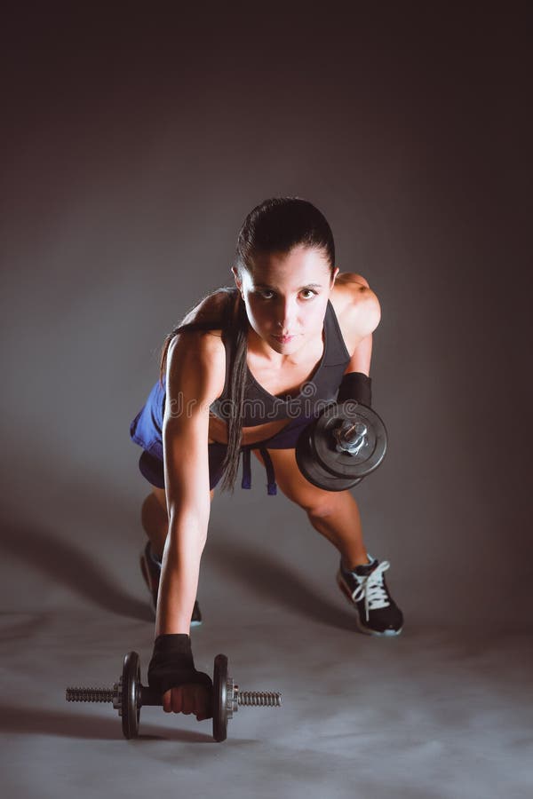 Cute Athletic Model Girl in Sportswear with Dumbbells in Studio Against  Black Background. Ideal Female Sports Figure Stock Photo - Image of  dumbells, beautiful: 88886168