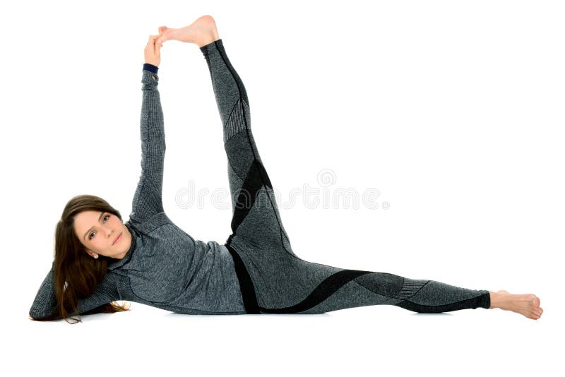 Young woman doing yoga asana Anantasana Side Reclining Leg Lift royalty free stock photography Young woman doing yoga asana Anantasana Side Reclining Leg Lift royalty free stock photography