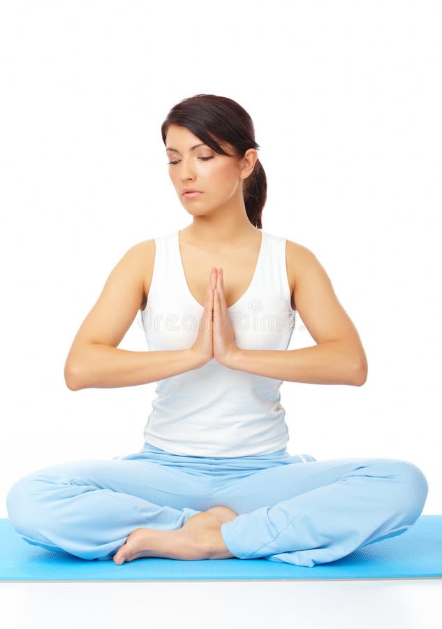 Young woman doing yoga exercise on mat