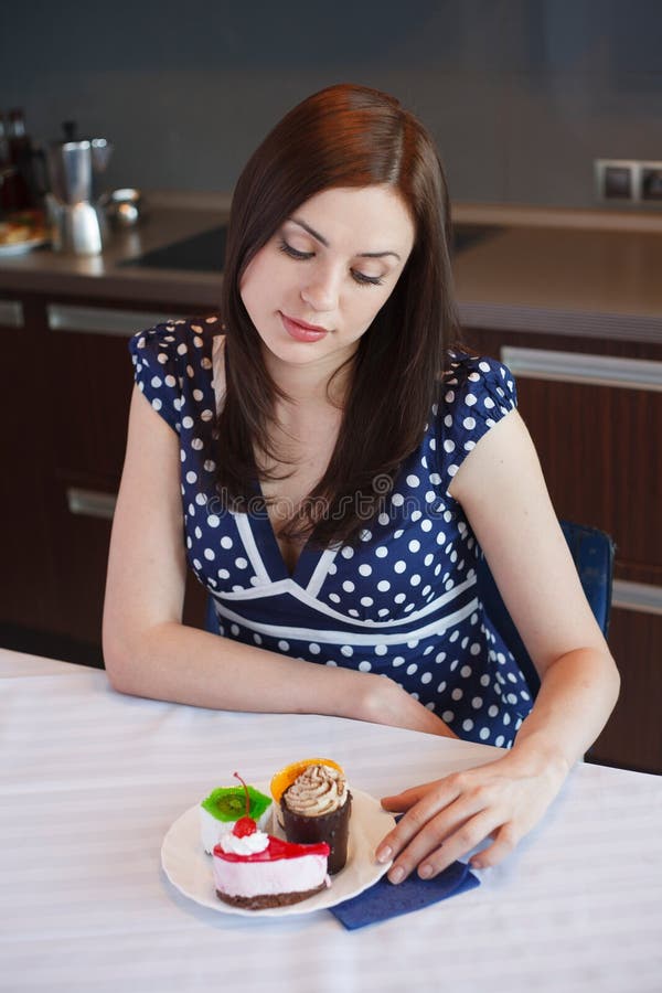 Young woman is dreaming about cake royalty free stock photo