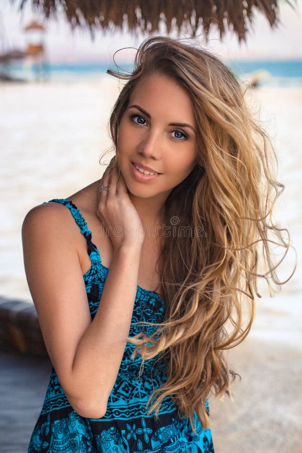 Young woman in dress on the beach