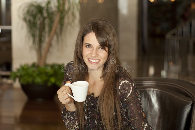 Young woman drinking coffee