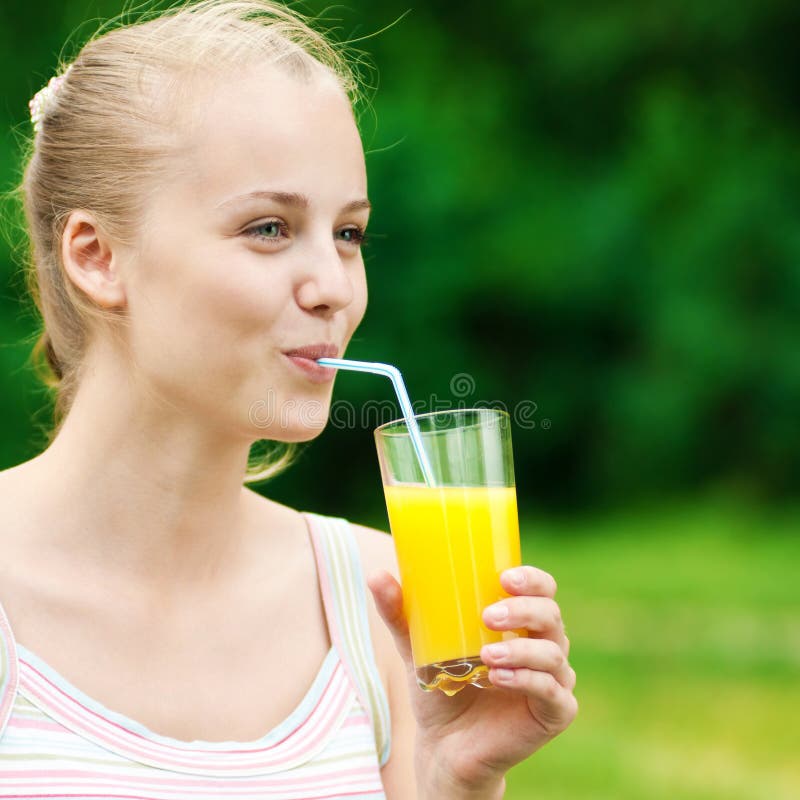 drinking orange juice outdoor young woman caucasian