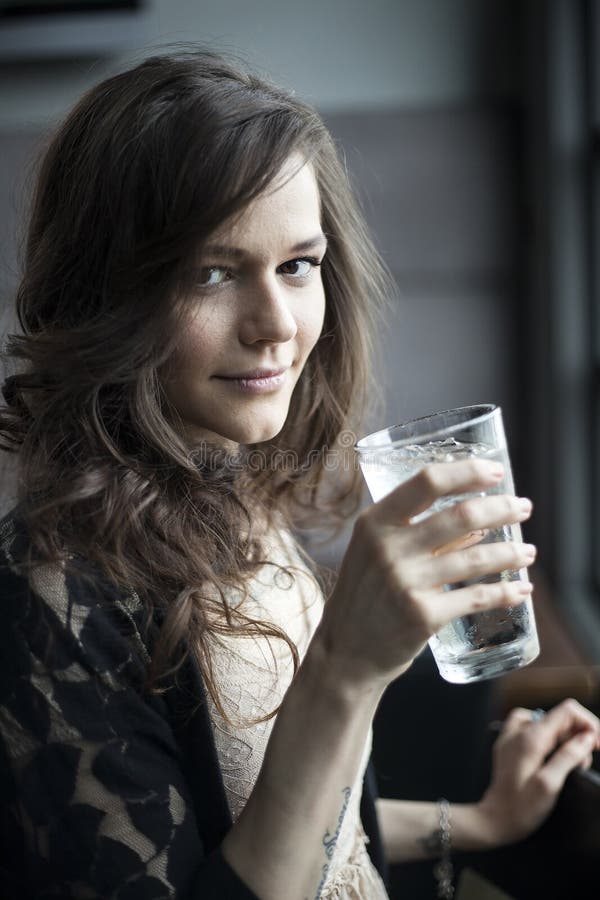 Young Woman Drinking a Pint Glass of Ice Water stock photos Young Woman Drinking a Pint Glass of Ice Water stock photos