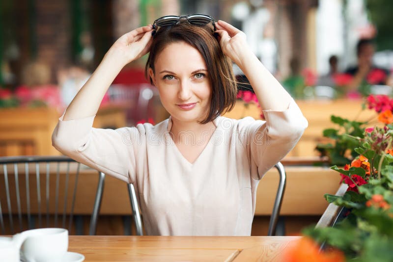 Young Woman Drinks Coffee In Cafeteria And Posing With Sunglasses Stock Image Image Of 