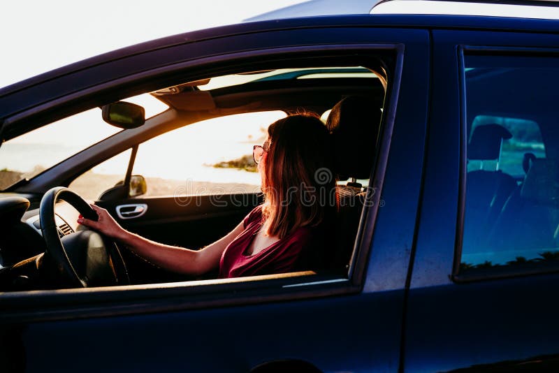 Young Woman Driving a Car at Sunset. Travel Concept Stock Photo - Image ...