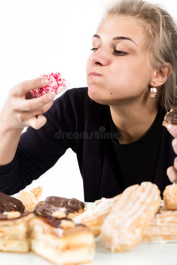Young Woman Eating Cupcakes with Pleasure after a Diet Stock Photo