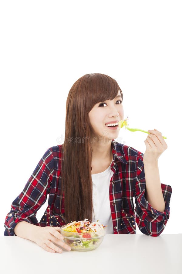 Young woman eating fruits and salad