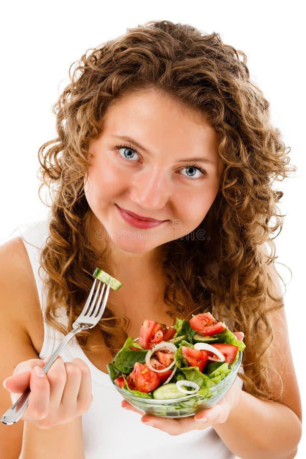 Young woman eating vegetable salad on white background stock photography Young woman eating vegetable salad on white background stock photography