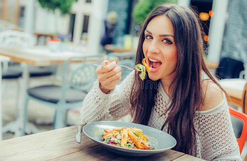 Young Woman Enjoying Food in a Restaurant, Having Her Lunch Break Stock ...