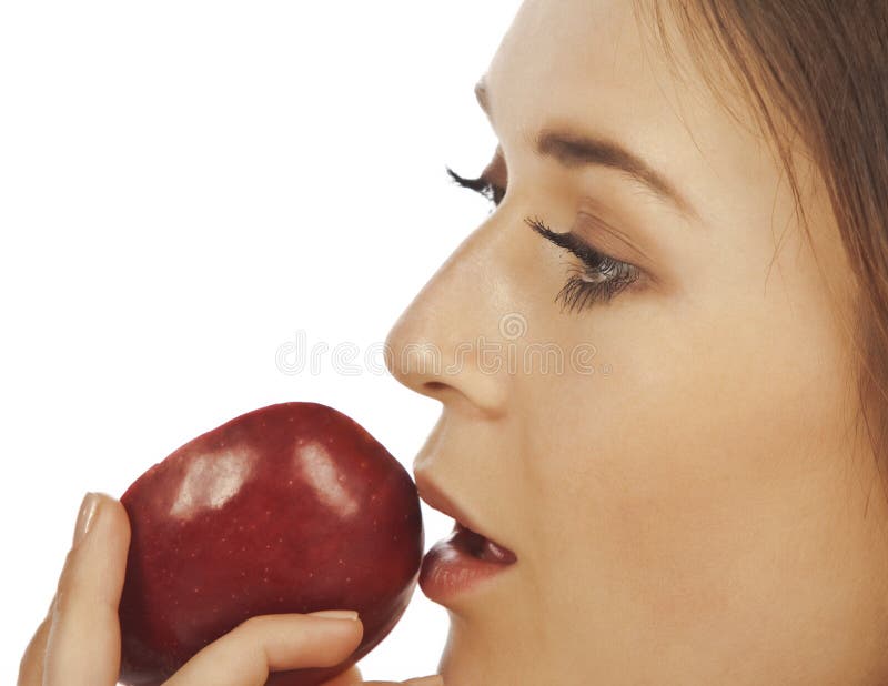 Young woman enjoying a piece of red apple