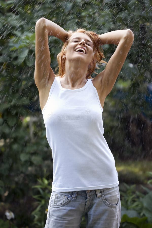 Young woman enjoying rain