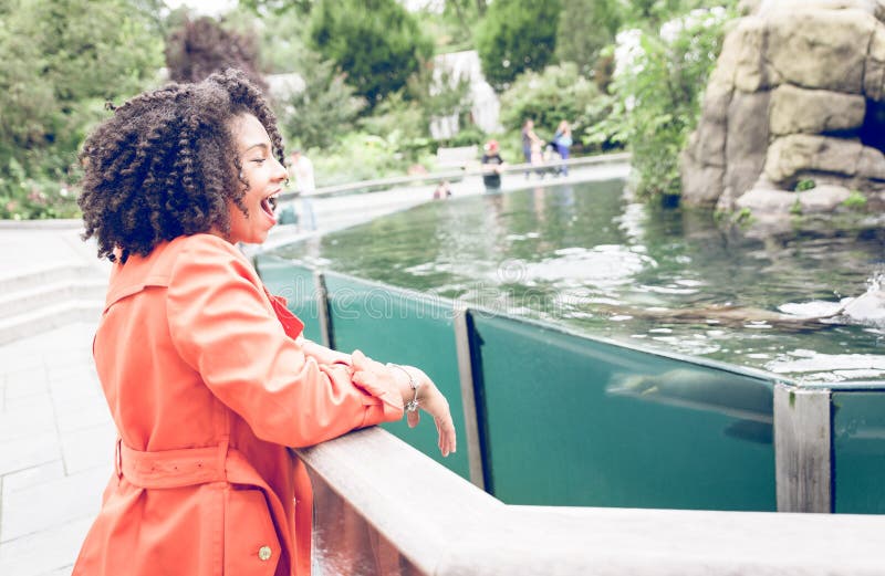 Young woman enjoying the show at the zoo