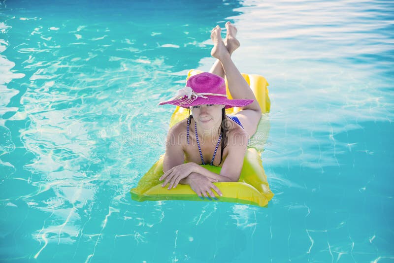Young woman enjoying a swimming pool