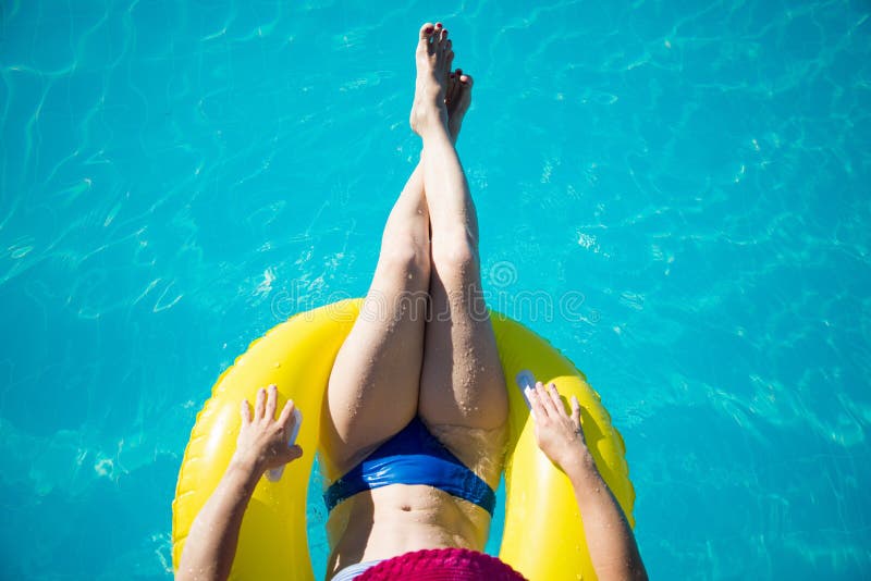 Young woman enjoying a swimming pool stock photos