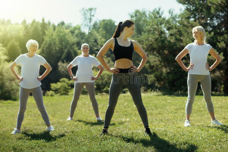 Young woman exercising with group of elderly people royalty free stock photo Young woman exercising with group of elderly people royalty free stock photo