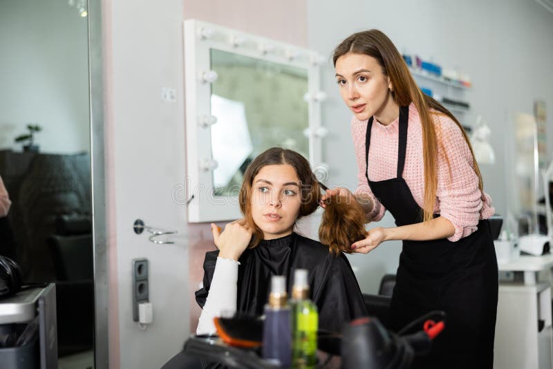 Young Woman Explains To the Hairdresser How she Wants To Get a Haircut ...