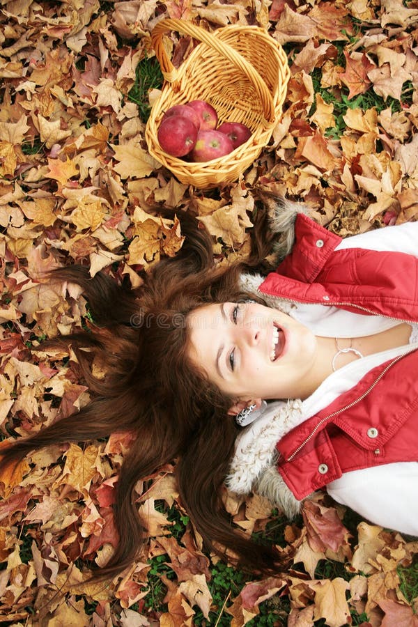 Young woman in fall leaves