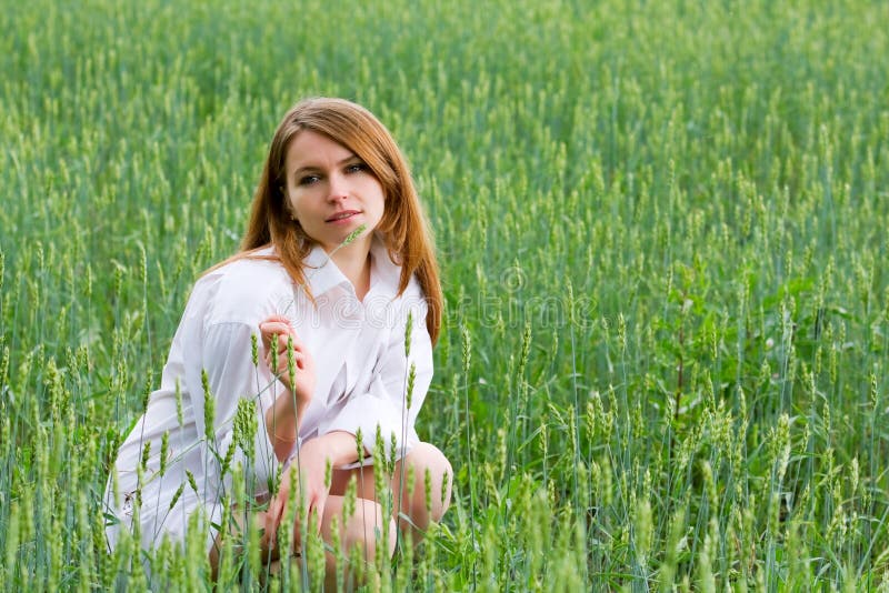 Young woman sitting in a grass