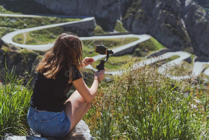 Young Woman Filming the Tremola Road in San Gotthard Using a Smartphone and  a Gimbal Stock Photo - Image of gottardo, grass: 147940328