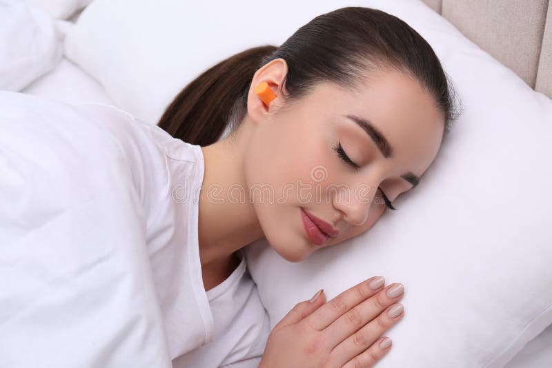 Young Woman with Foam Ear Plugs Sleeping in Bed Stock Photo Image of