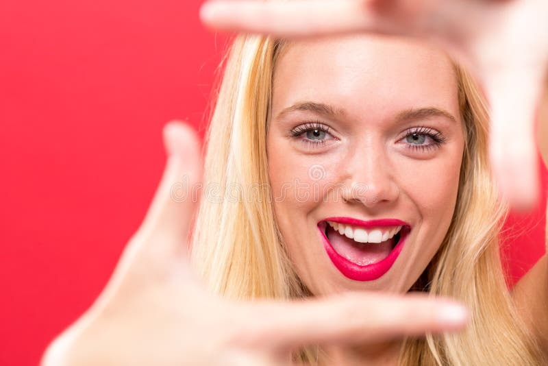 Young woman framing her face with her fingers