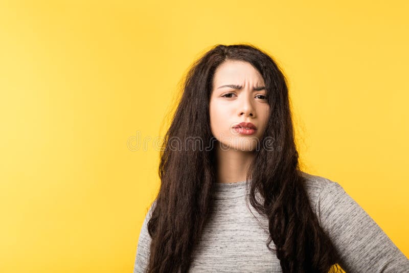 Young woman frowning skepticism doubt incredulous