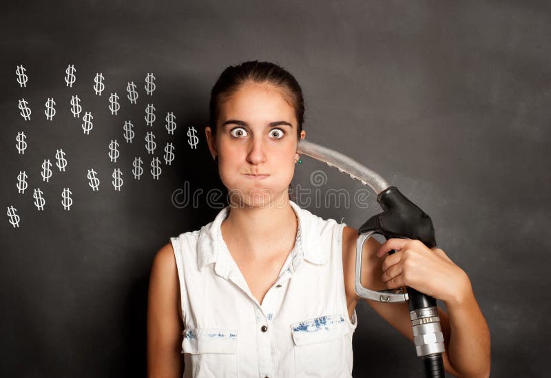 Young woman with a fuel pump nozzle