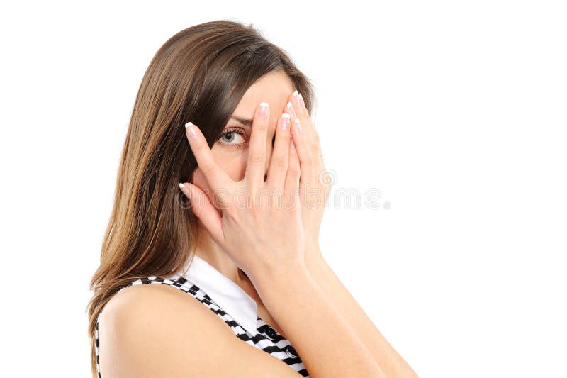 Young woman is gazing through her fingers