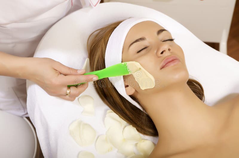 Young woman getting beauty skin mask