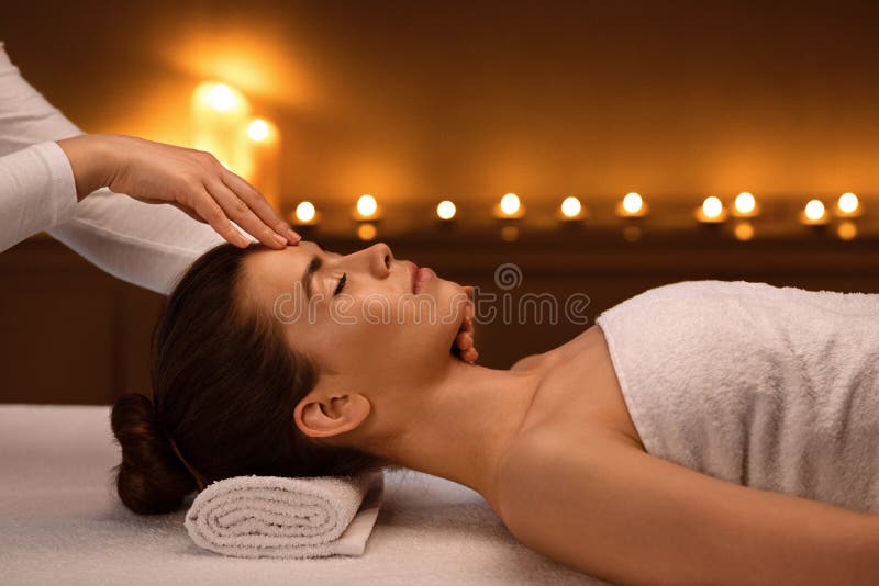 Spa Therapist Making Relaxing Head Massage For Young Beautiful Lady