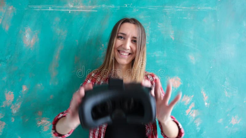 Young woman giving virtual reality headset