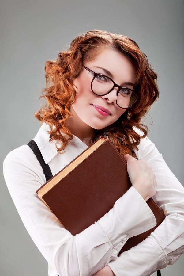 Young woman in glasses with a book stock photo