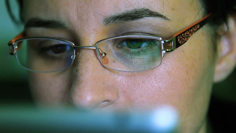 Young woman with glasses working on a tablet computer