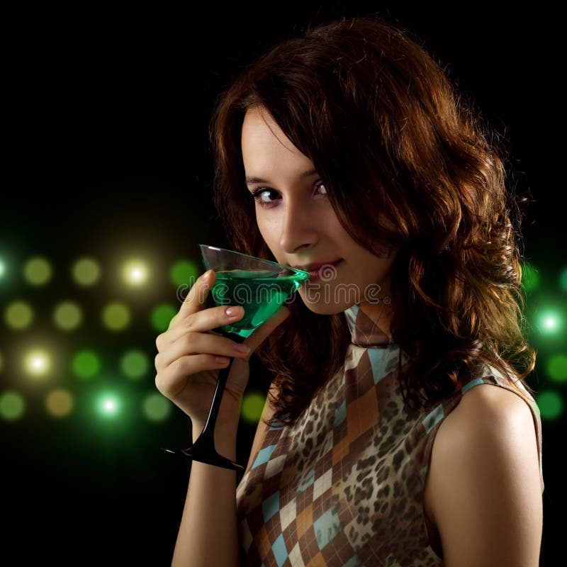 Young woman with a green cocktail