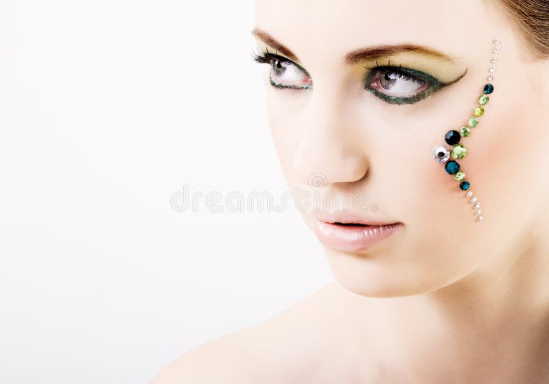 Young woman with green creative makeup royalty free stock image