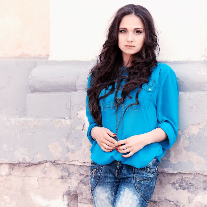 Young woman on a grunge wall backround