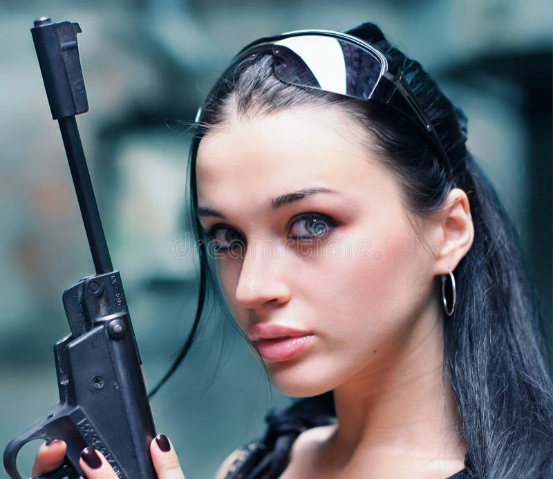 Young woman with gun wearing glasses stock image Young woman with gun wearing glasses stock image