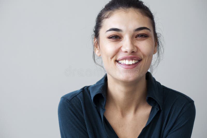 Young woman happy on gray background stock photo Young woman happy on gray background stock photo