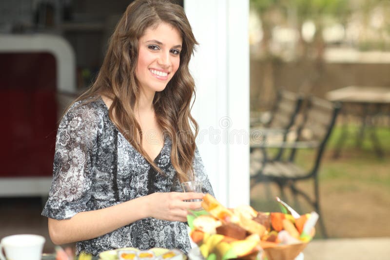 Young woman having breakfast outside