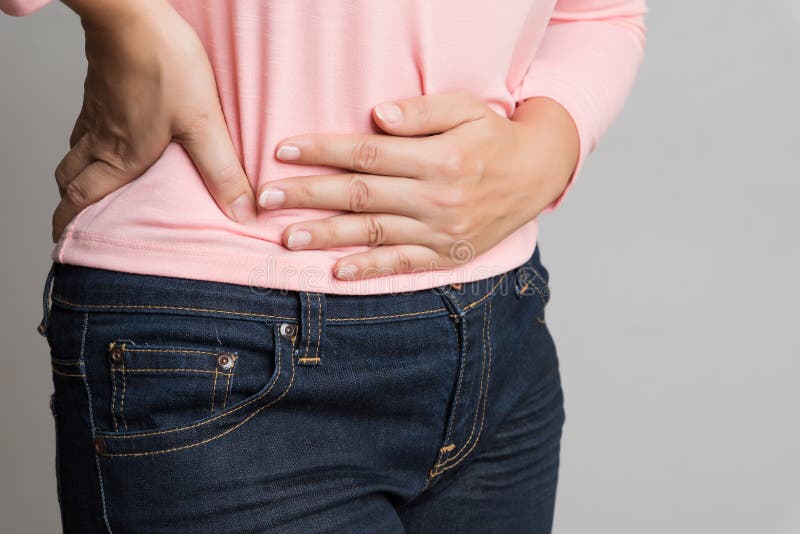 Young woman having painful stomachache. Chronic gastritis. Abdomen bloating and healthcare concept stock images