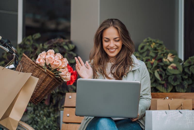 Young woman having a video call with a laptop royalty free stock photography Young woman having a video call with a laptop royalty free stock photography