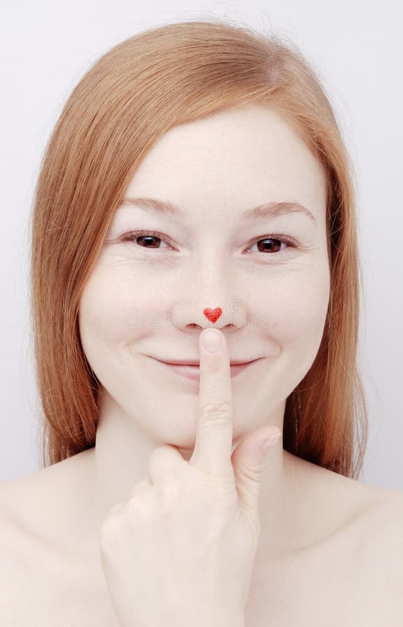 Young woman with heart on nose