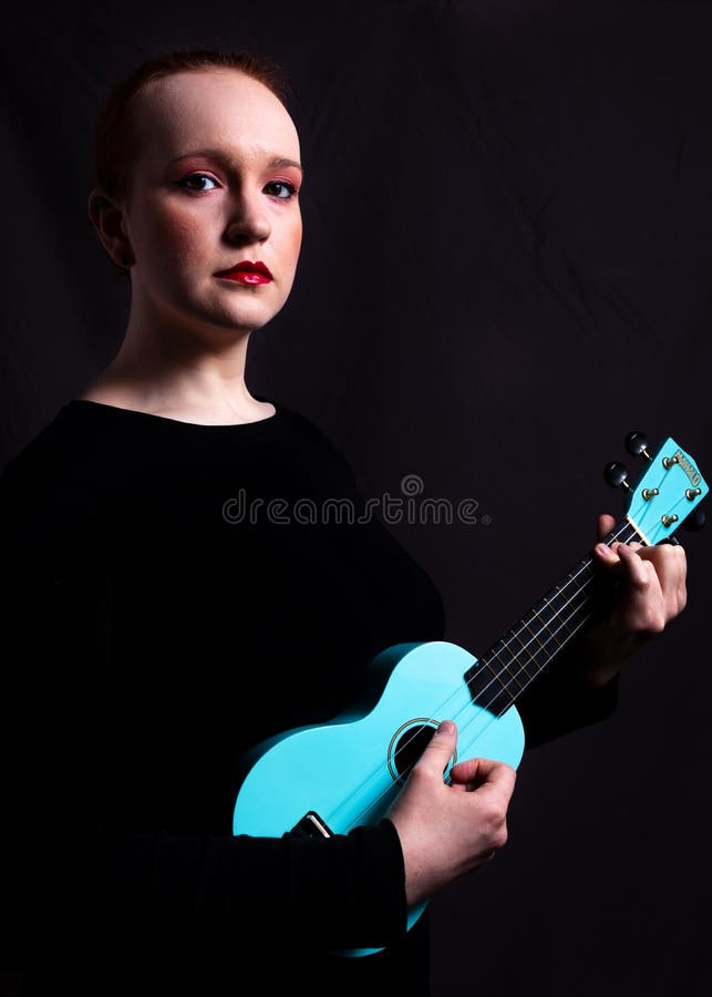 Young Woman in Make Playing a Ukulele. Stock - Image of female, theatre: