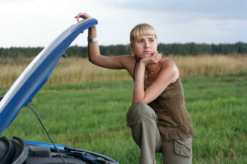 Young woman and her broken car